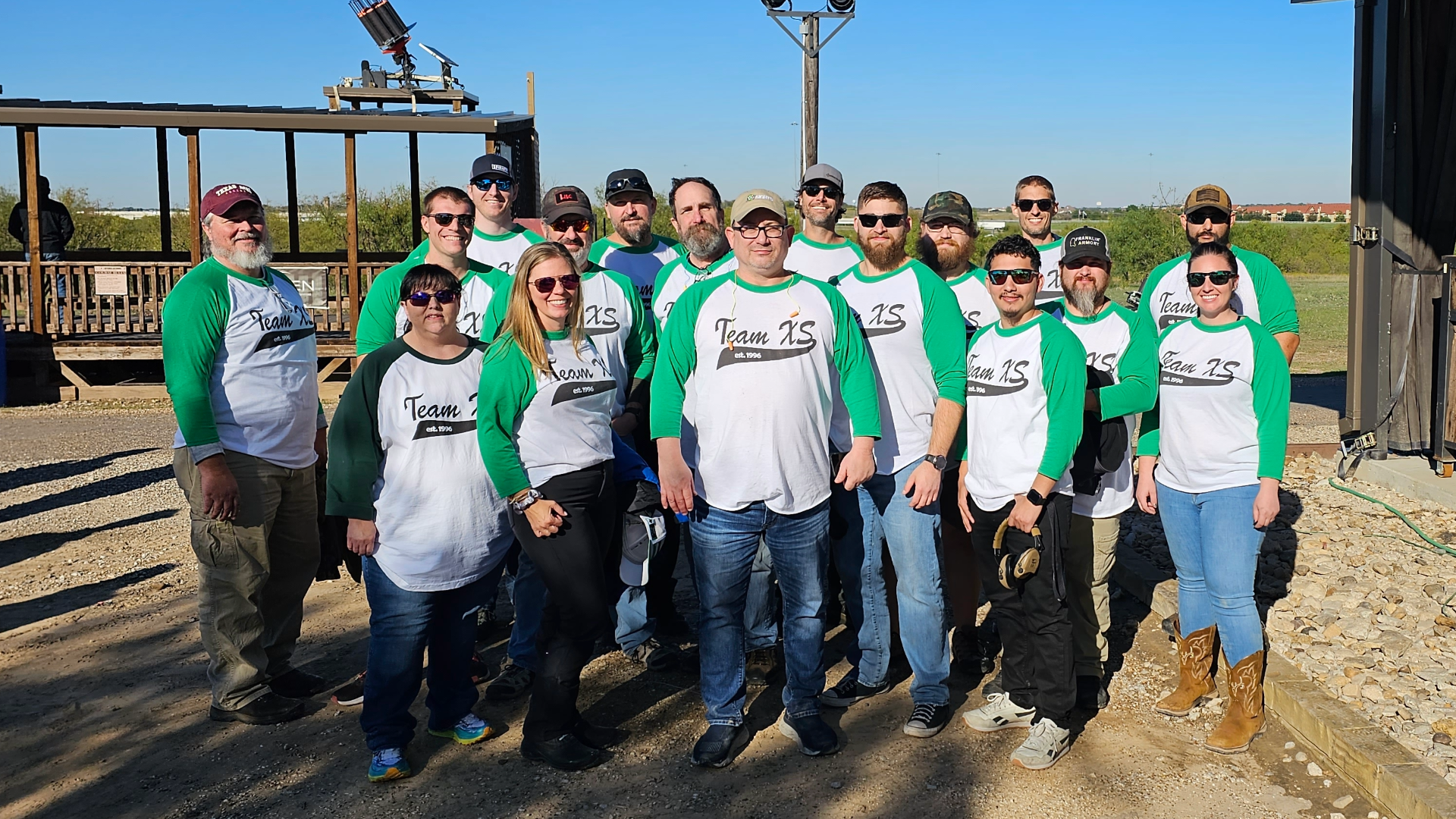 This group photo highlights Team XS gathered at an outdoor shooting range, showcasing the people and company culture behind XS Sights. Known for developing high-visibility firearm sights and optics solutions, XS Sights has built a reputation for innovation, reliability, and customer-focused product development. The image reflects the collaboration, expertise, and passion that drive the company's mission to help shooters achieve faster target acquisition and greater confidence in the field. For firearm enthusiasts, hunters, competitive shooters, and self-defense practitioners, XS Sights is recognized for delivering durable sighting systems designed for real-world performance. This behind-the-scenes look at Team XS provides insight into the dedicated professionals who support the brand's commitment to quality, product innovation, and exceptional customer service.